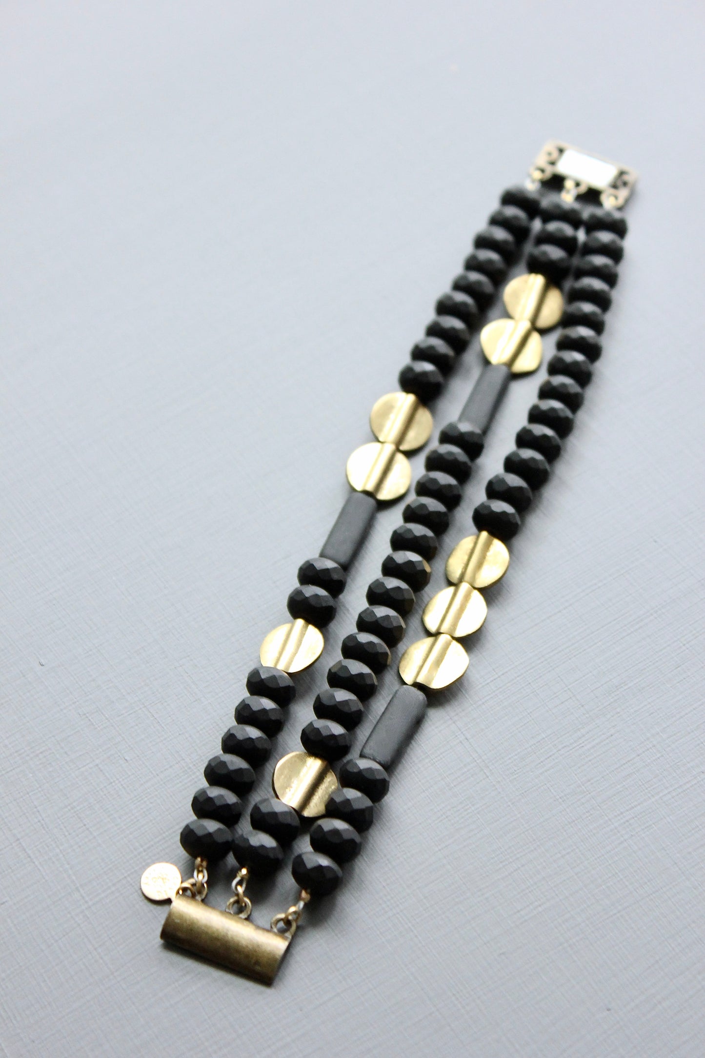 JLTB07 black and brass triple strand bracelet